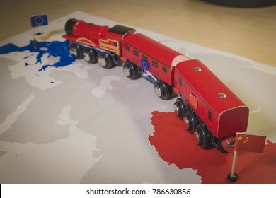 Toy train connecting Europa and China. Symbolizing the New Silk Road or one belt one road Chinese strategic investment in the 21st century. Economic project to connect EU, Central Asia and China