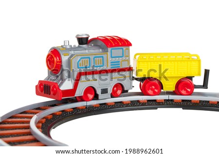 toy train with freight car trolley on railway tracks, isolated on white background, children's railway with steam locomotives, battery powered train