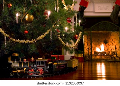 A Toy Train Under A Christmas Tree.