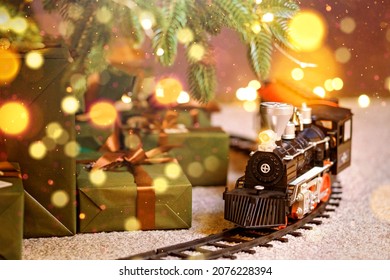 Toy Train Under Christmas Tree. Home Party Decoration