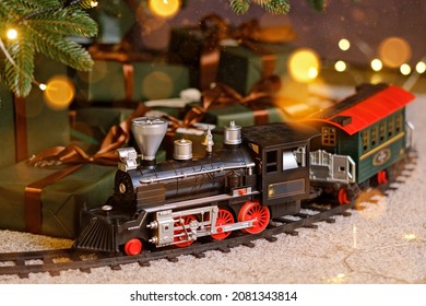 Toy Train Under Christmas Tree. Home Party Decoration