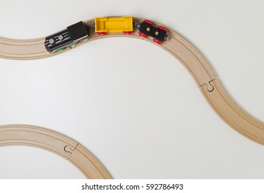 Toy Train And Wooden Rails On White Background. Top View.