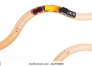 Toy Train And Wooden Rails On White Background. Top View.