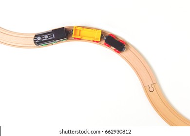 Toy Train And Wooden Rails On White Background. Top View.