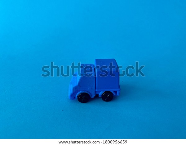 A toy truck with blue\
background