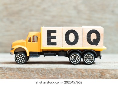 Toy truck hold alphabet letter block in word EOQ (Abbreviation of Economic order quantity) on wood background - Shutterstock ID 2028457652