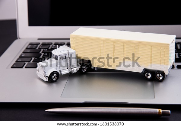 Toy truck and
laptop on a black
background