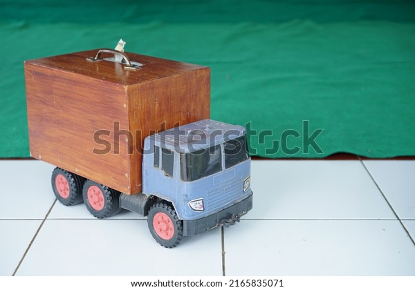 A toy truck loaded\
with wooden boxes