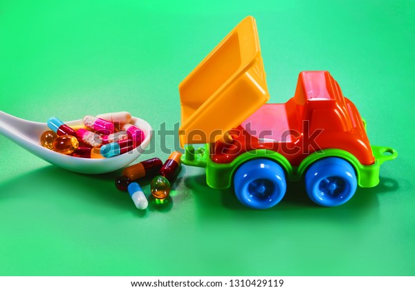 toy truck with\
multi-colored medical\
capsules.