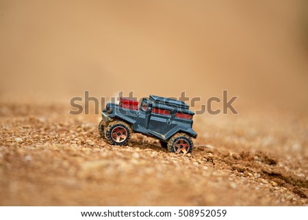 toy truck offroading on mud with soft focus and beautiful bokeh