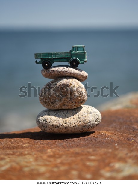 Toy Truck on Rocks\
by the Ocean - vertical