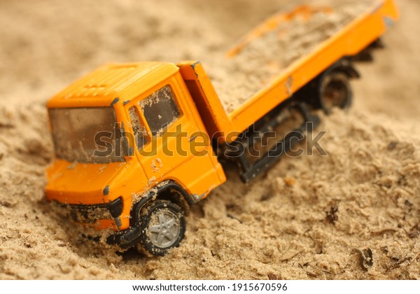 a toy truck in the\
sand