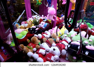 Toy vending machine or claw machine with plush soft toys on display inside for customers to have a fun time trying to grab the prizes with a mechanical claw. Gaming machine at an entertainment outlet.