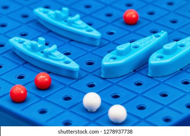 Toy War Ships And Submarine Are Placed On The Playing Board In The Game Battleship