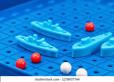 Toy War Ships And Submarine Are Placed On The Playing Board In The Game Battleship