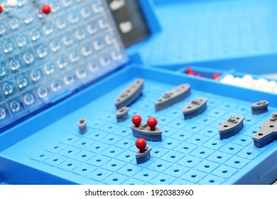 Toy War Ships And Submarine Are Placed On The Playing Board In The Game Battleship