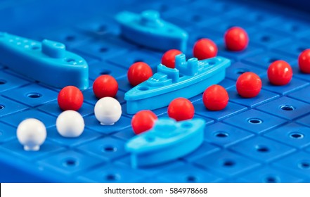 Toy War Ships And Submarine Are Placed On The Playing Board In The Game Battleship