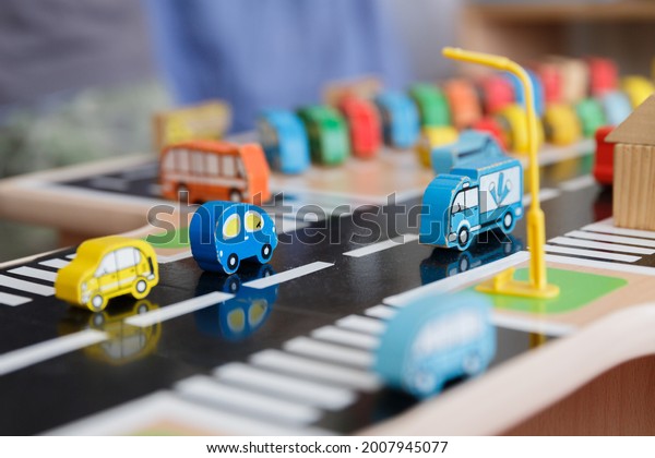 A toy wood town of colorful buildings and\
cars for teaching the rules of the\
road