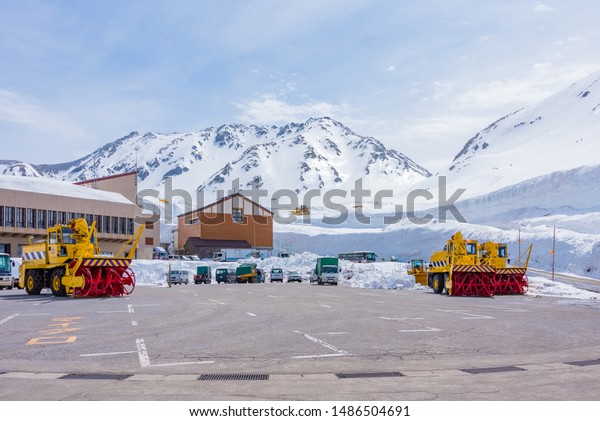 TOYAMA,JAPAN - APRIL 17,2018 ; Group of Kuma Taro\
snow plow truck on car parking after finished work, Heavy machines\
clearing the road from snow at Murodo station on the Tateyama\
Kurobe Alpine\
Route.