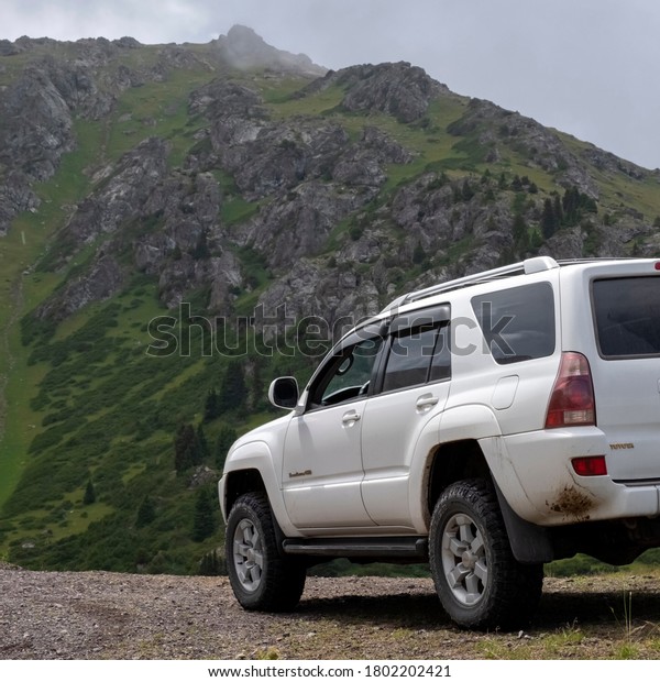 Toyota 4runner 4x4 off-road car on gravel\
road in green mountains. Mountain trail landscape. Adventure\
travel. Ketmen mountain gorge and mountain pass in Kazakhstan.\
25.07.2020 Almaty,\
Kazakhstan.