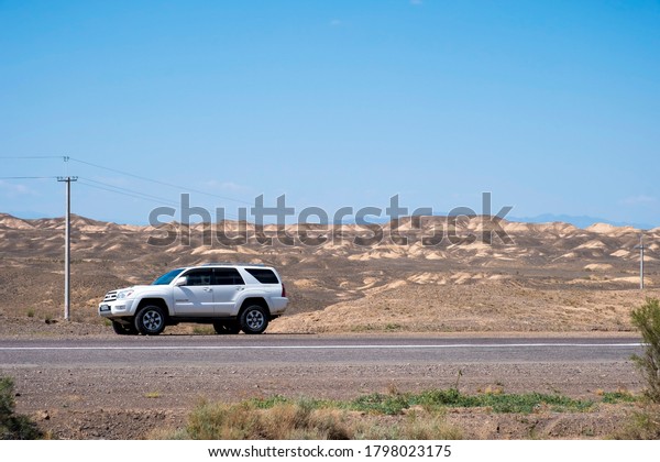 Toyota\
4runner SUV  in desert road with blue sky. 4wd SUV car road canyon\
desert. Outdoor landscape. Travel in Kazakhstan concept. \
\
\
25.07.2020, Charyn national park, Kazakhstan.\
