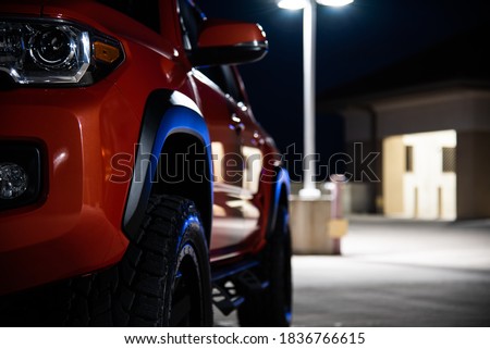 Toyota Tacoma orange at night