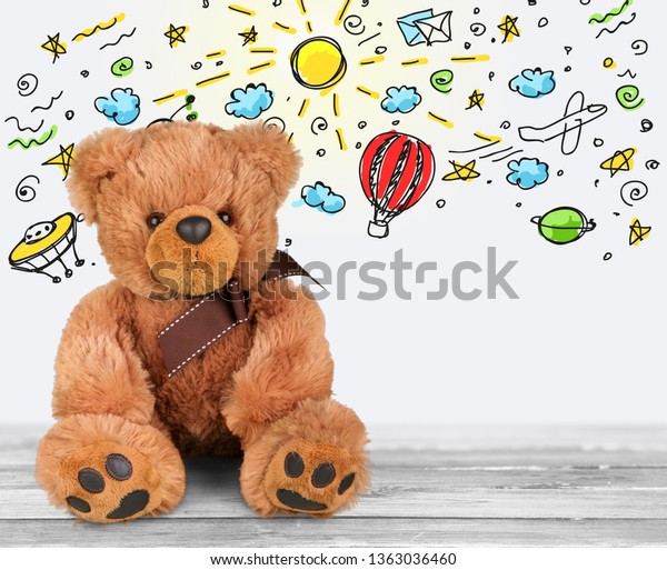 Toys bear and illustration\
on desk