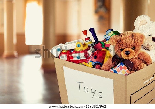 Toys\
collection in card box on the room\
background