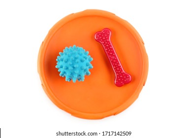 Toys For A Dog: Frisbee Disc, Spiked Ball And Chewing Bone Isolated On White Background.