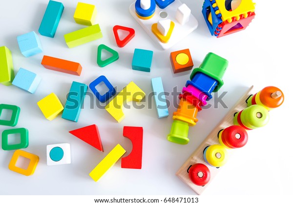 toys kids background. Wooden cubes with numbers and\
colorful toy bricks on a white background. frame made of\
accessories for children. top\
view.