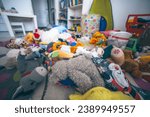Toys laying on the floor in a kids room. Mess at home. Clining kids toys concept.