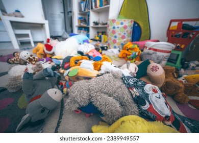 Toys laying on the floor in a kids room. Mess at home. Clining kids toys concept.