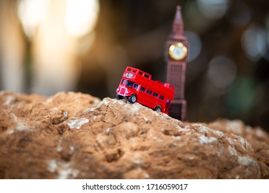 Toys that represent two of the main symbols of the city of London, red bus and The London famous Big Ben model on blurred background. decoration​ image​ contain​ cert