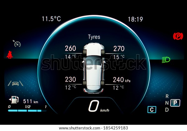 TPMS (Tyre Pressure Monitoring System) with\
temperature measurement monitoring display on car dashboard panel.\
Checking tires pressures and temperature. Car cluster with\
speedometer and fuel\
gauge.