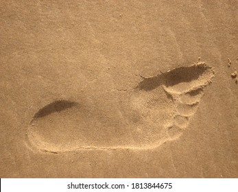 Trace in the fine granular sand , the trace is from a footprint of human, the prints of the toes are clearly visible, so no shoes or sock were worn