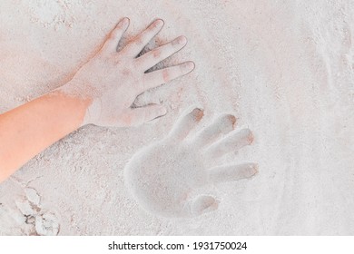 Trace or handprint of a young girl close up on the white beach sand background.
