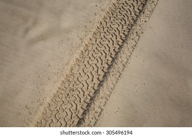 The Trace Of A Tyre In The Sand On The Beach