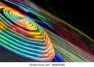 Traces of colored lights on a fairground attraction