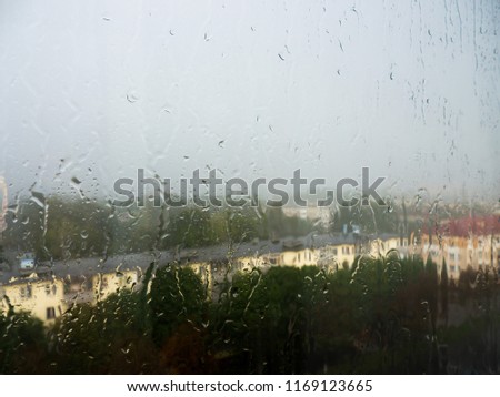 Similar – Rainy day I View through a wet window pane onto a busy street