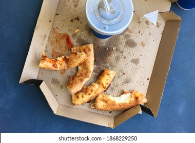 Traces Of Eaten Junk Food With Soft Drink Cup, Shot From Above. Unhealthy Eating Habits.