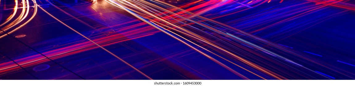 Traces Of Headlights And Tail Lights From Cars In Busy Traffic Under Blue Street Light. Colorful Vehicle Trails Long Exposure.