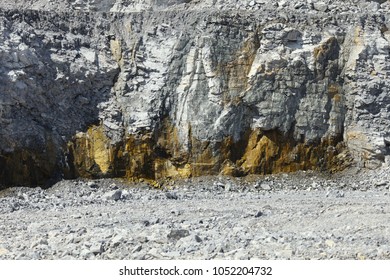 Traces Of Red Color On The Wall Of The Quarry From The Impact Of Groundwater. Mining Industry.