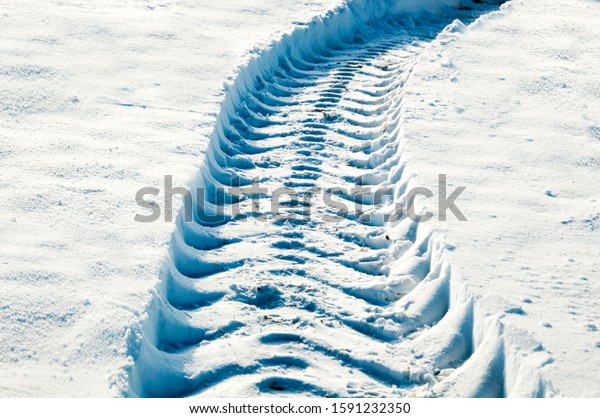 Traces of snow removal from snow removal special\
equipment.\
Snowfall. Snow removal. Snow cover. Road cleaning from\
snowfall in winter.
