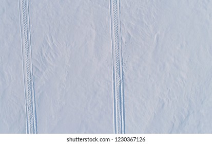 Traces Of The Snowmobile On Snow. Top View. Aerial Foto.