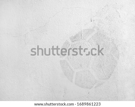 traces of soccer ball imprint on old white concrete wall, dirt stain on cement surface caused by kicking soccer ball hits stadium wall, abstract sports background, close up white copy space