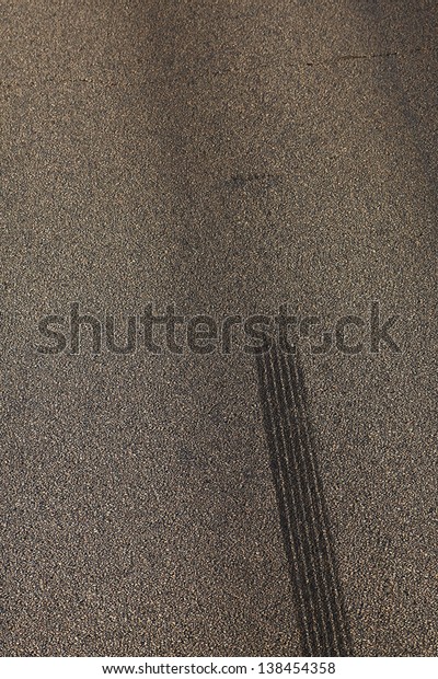Traces from tires on an\
asphalt covering