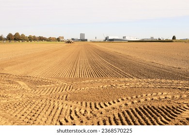 traces of tractor wheels in the sand, traces of a tractor, a tractor plows a field, autumn work in a field, tractor in a field, dry earth with traces, traces of a car, relief, soil in  - Shutterstock ID 2368570225