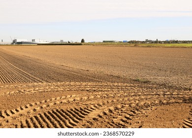 traces of tractor wheels in the sand, traces of a tractor, a tractor plows a field, autumn work in a field, tractor in a field, dry earth with traces, traces of a car, relief, soil in  - Shutterstock ID 2368570229