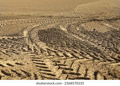 traces of tractor wheels in the sand, traces of a tractor, a tractor plows a field, autumn work in a field, tractor in a field, dry earth with traces, traces of a car, relief, soil in  - Shutterstock ID 2368570235