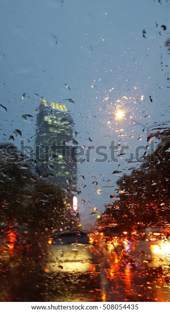 Tracfic raining and\
the city night in the\
car
